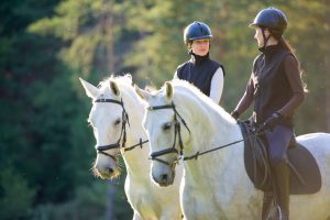Women riding horses